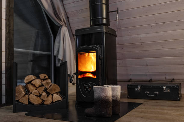 istock an old fireplace with a fire in a wooden house with firewood 2112012006