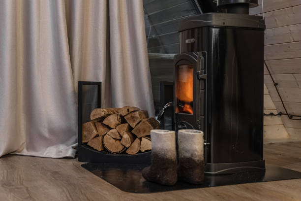 istock an old fireplace with a fire in a wooden house with firewood 2112012014