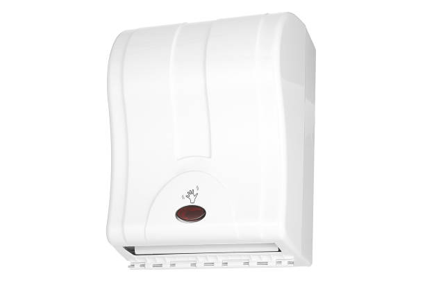 Automatic paper towel dispenser on green tiled wall