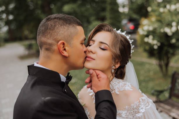 istock Wedding. Love and couple in garden for wedding. Celebrating the ceremony and commitment. Save the date. Trust. The groom embraces the bride. Tender kisses. Couple in love. Wedding portrait 2112052872