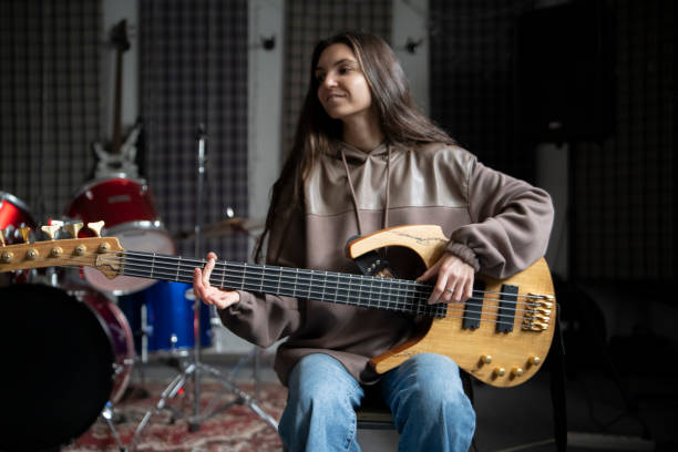 istock Musician Practicing Acoustic Guitar in Soundproofed Home Studio 2112060568