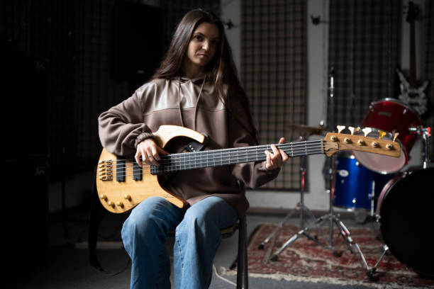 istock Musician Practicing Acoustic Guitar in Soundproofed Home Studio 2112060570