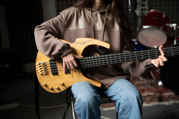 istock Young Musician Playing electric Guitar in a Studio Setting During a Rehearsal, playing accord 2112060578