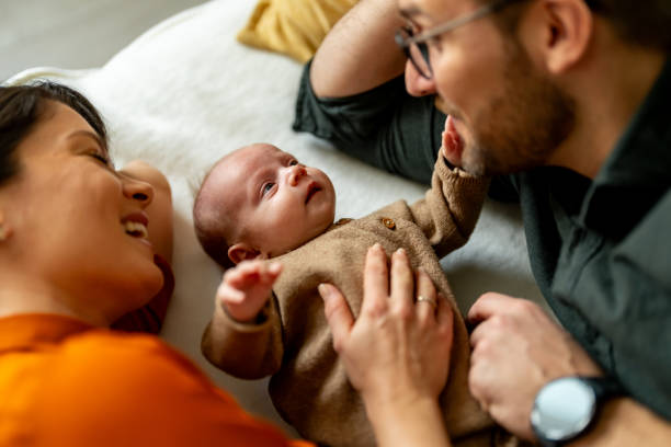 istock Couple enjoying time at home with adopted baby 2112096911
