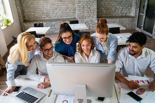 Large group of multi-tasking entrepreneurs working on a business meeting in the office.