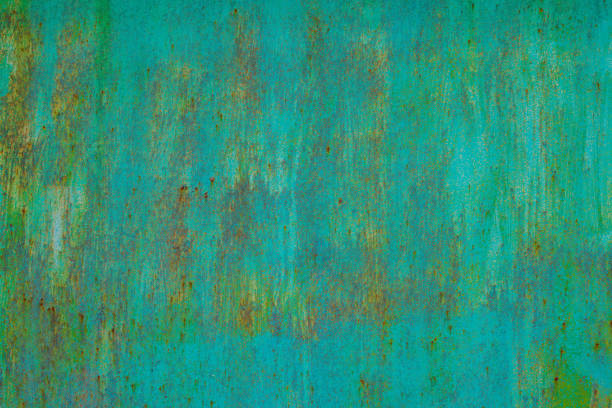 faded green paint on surface of flat sheet steel with stains of rust - full-frame background and texture.