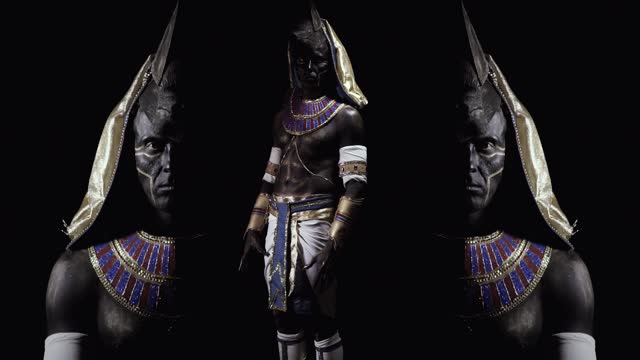 Anubis appearing from the dark, mirror effect on the sides