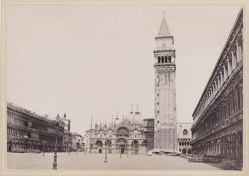 Historical view of Venice, Italy: St Mark's Square (Piazza San Marco). In the background the old St Mark's Campanile (Saint Mark's Bell Tower, destroyed in 1902) and the St Mark's Basilica. Original photograph (scanned and slightly restored) from the book 