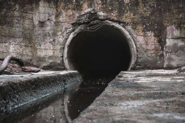 istock Sewage drainage pipe, sewage flows from the collector. Environmental pollution 2112155171