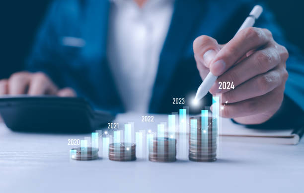 istock Close-up businessperson analyzing a holographic financial chart. Conceptual image for financial analysis, forecasting, and digital economy. Growth of year, 2024, businessman calculates financial data. 2112159451