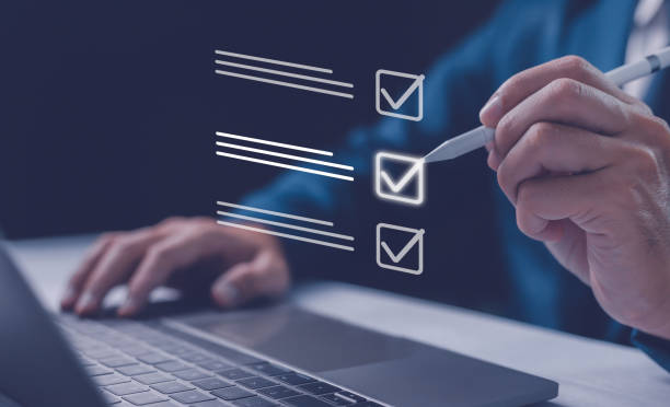 istock Checklist concept, Businessman mark checkboxes, Survey form, check marks on checklist, filling online form and answering questions. List options business employee security procedures followed office. 2112159460