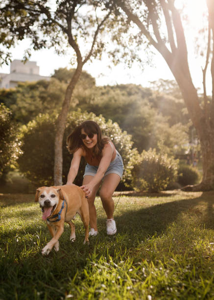 istock Woman playing with her dog 2112190205