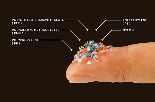 What micro plastic is made of - Chemical ingredients.\nClose up of microplastic on finger concept of water pollution and global warming