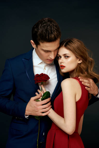 istock luxury couple hug romance relationship rose over dark isolated background 2112217082