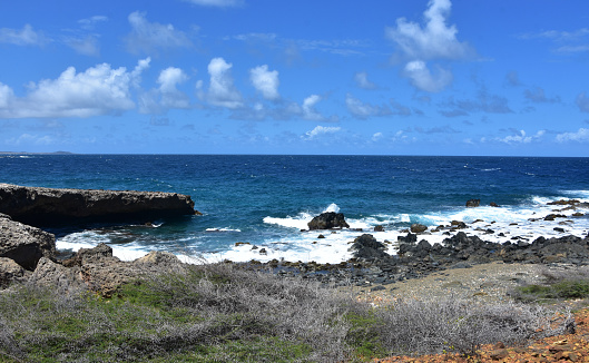 Scenic views of waves crashing against the lava rock on the shore.