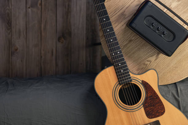 istock Acoustic guitar and speaker on the table, top view, copy space. 2112227903