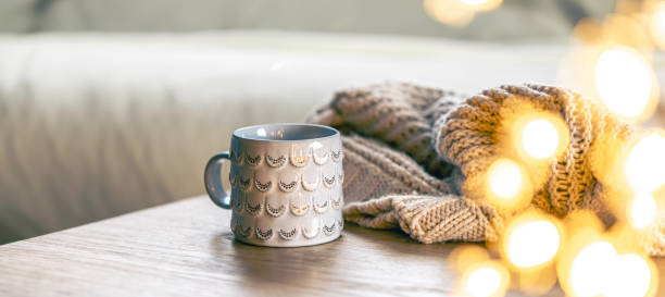 istock Cozy background with shiny gray cup, bokeh lights and knitted element. 2112229518
