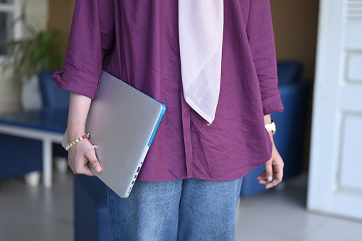 Close Up of business woman holding laptop