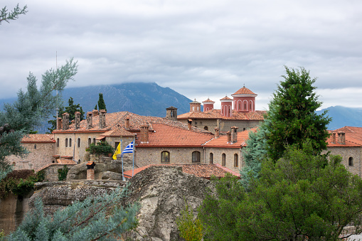 Greece. Summer cloudy day in Meteora. Crosses and red roofs of a Greek monastery