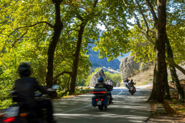 istock Group of Motorcyclists on a Forest Mountain Road 2112241723