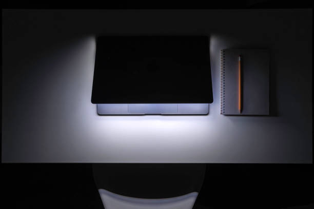 istock Laptop in the dark at night on the desktop. 2112251116