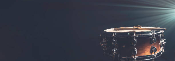 istock Snare drum on a dark background isolated with space for a text. 2112265498