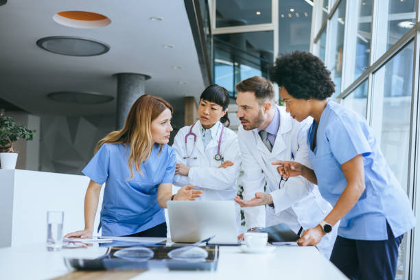 istock Healthcare team collaboratively using a laptop 2112295771