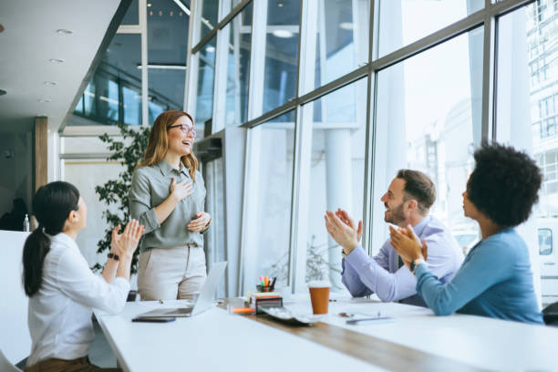 istock Colleagues applauding presentation in office 2112305065