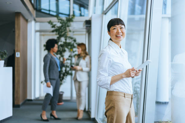 Woman posing with digital tablet in office