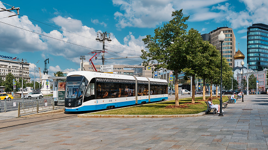 Urban passenger transport, modern city streetcar rides on Tverskaya Zastava Square, cityscape: Moscow, Russia - July 22, 2022