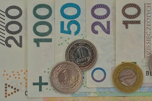 polish zloty bank notes and coins sorted from 200 to 10 closeup overhead shot