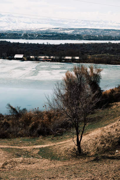 Small lake partly frozen in springtime