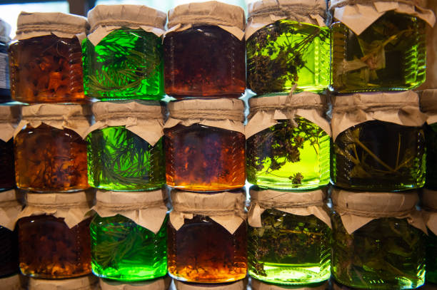istock Assorted herbal tinctures in glass jars with craft paper lids. 2112330971