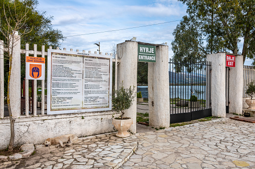 Butrint, Albania. 16 March 2024. Entrance to Butrint National Park in Albania, with a stray dog asleep.