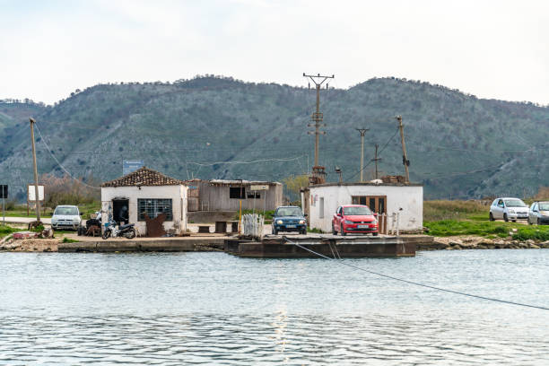 Butrint, Albania. 16 March 2024. Small car ferry crosses Butrint National Park waterway