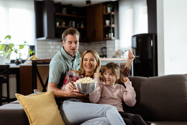 istock Family Movie Night: Engrossed in Thrilling Scenes at Home 2112352272