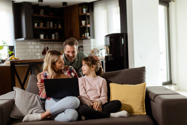 istock Family Bonding Time With Laptop in Cozy Home Setting 2112352275