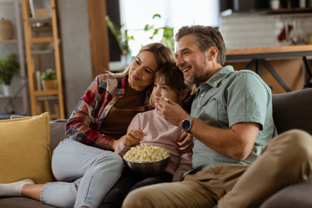 istock Family Movie Night: Engrossed in Thrilling Scenes at Home 2112352278