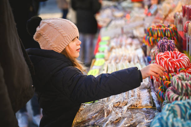 istock Little girl choosing candy cane. 2112377260