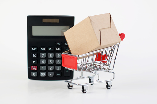Shopping cart  with paper box and calculator . Shopping concept ,price compare sale.