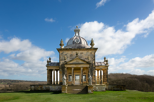 Castle Howard, York, UK - March 23, 2024.  A panoramic landscape of The Temple Of The Four Winds in the gardens of the British Stately Home of Castle Howard on a bright sunny day with copy space