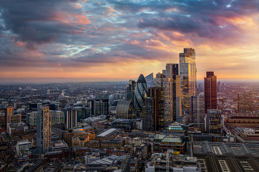 Beautiful sunset view of the financial skyscrapers at the City of London, England, until back to Tower Bridge