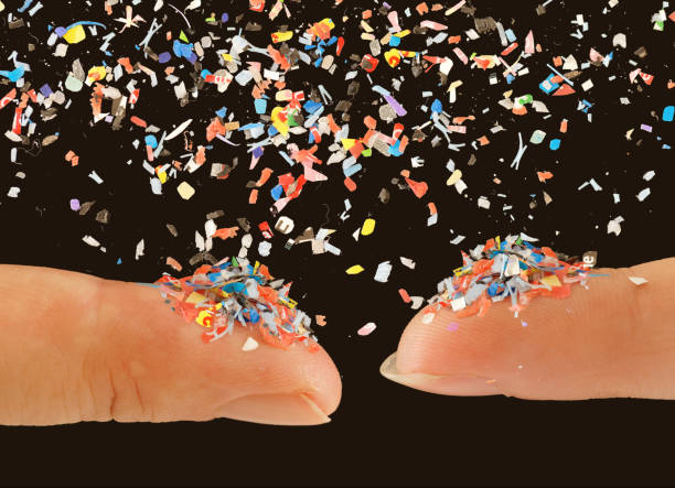 istock Close up of microplastic on finger concept of water plastic pollution and global warming 2112422320