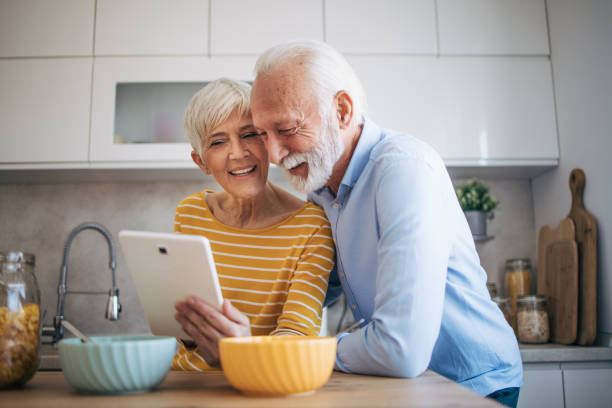 istock Senior heterosexual couple enjoying time together in the kitchen 2112426096