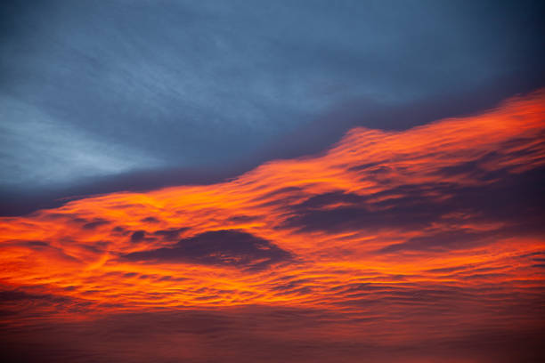 Sunrise with orange clouds and blue skies