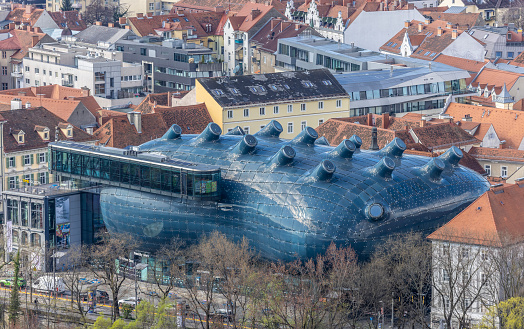 Graz, Austria : March 25, 2024 : view from schlossberg hill to Kunsthaus Graz ( Friendly Alien). Graz was the European Capital of Culture in 2003 and the Kunsthaus Graz was opend as part of Joanneum