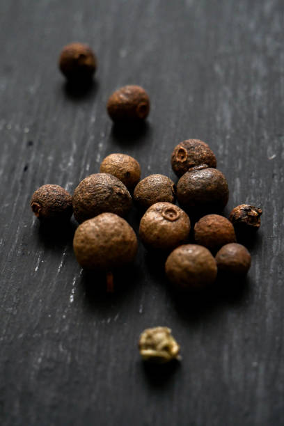 istock Black pepper peppercorns on a black background 2112446712