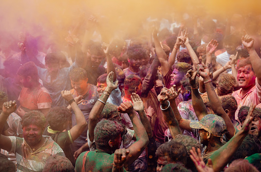 Revellers dancing in the beat of music as they celebrate Holi on a street, the Hindu spring festival of colours on March 25, 2024 in Guwahati, Assam, India. Holi, also known as the Festival of Colors or the Festival of Spring, is one of the most vibrant and joyous festivals in India.