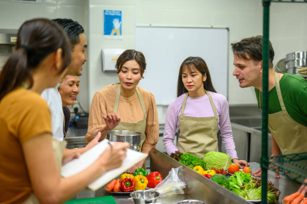 istock Culinary Mastery Unveiled: Asian Chef's Instructional Session at Professional Cooking School 2112481222