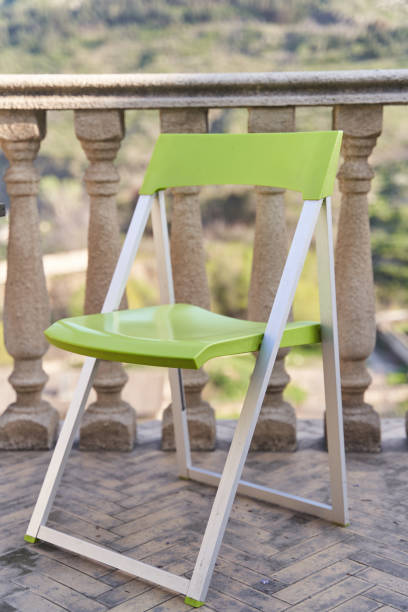 istock Green folding chair on the terrace with balustrades 2112486474